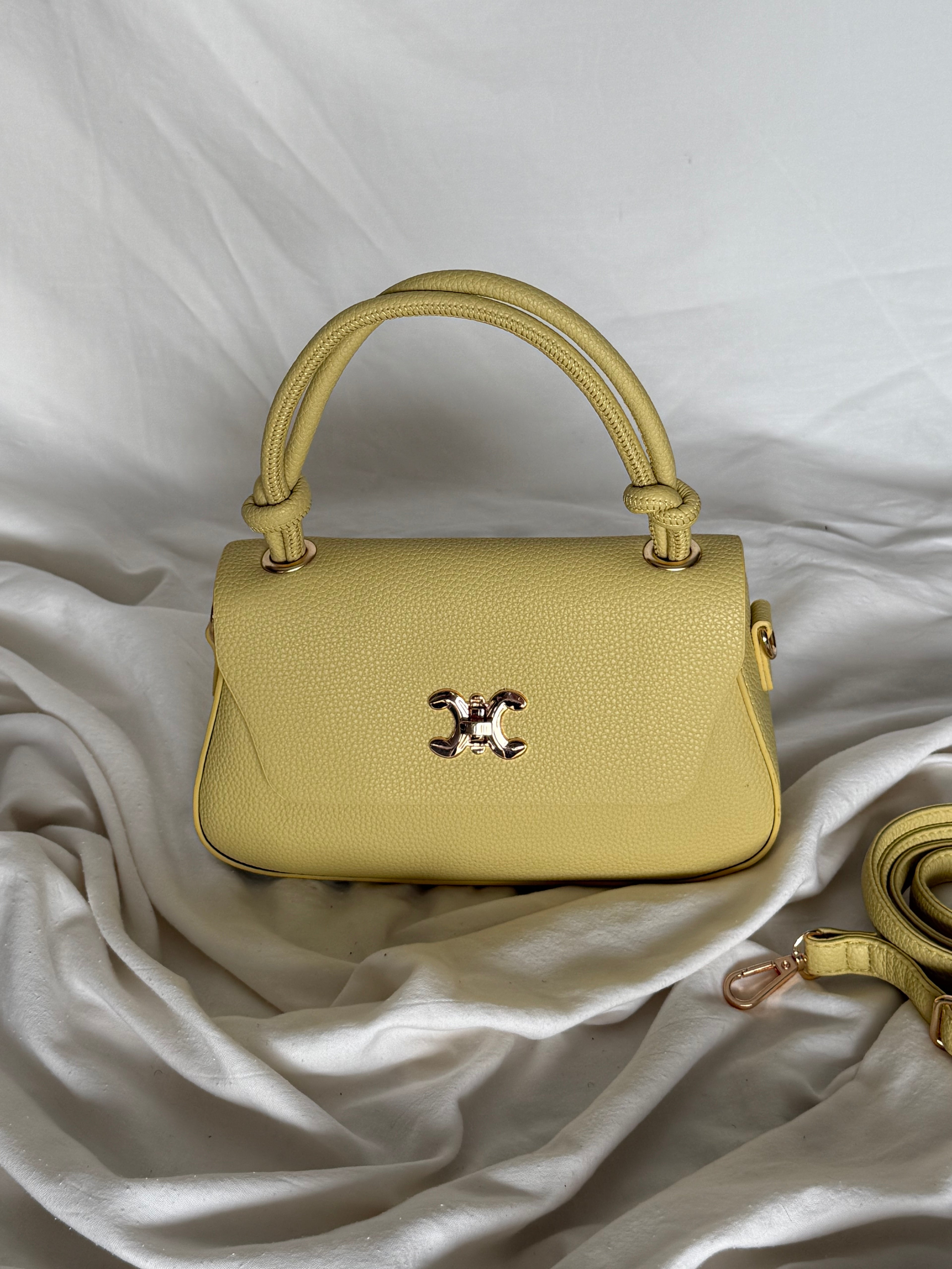 Κομψό κίτρινο παλ τσαντάκι χειρός με επιπλέον λουρί για να φοριέται και χιαστί