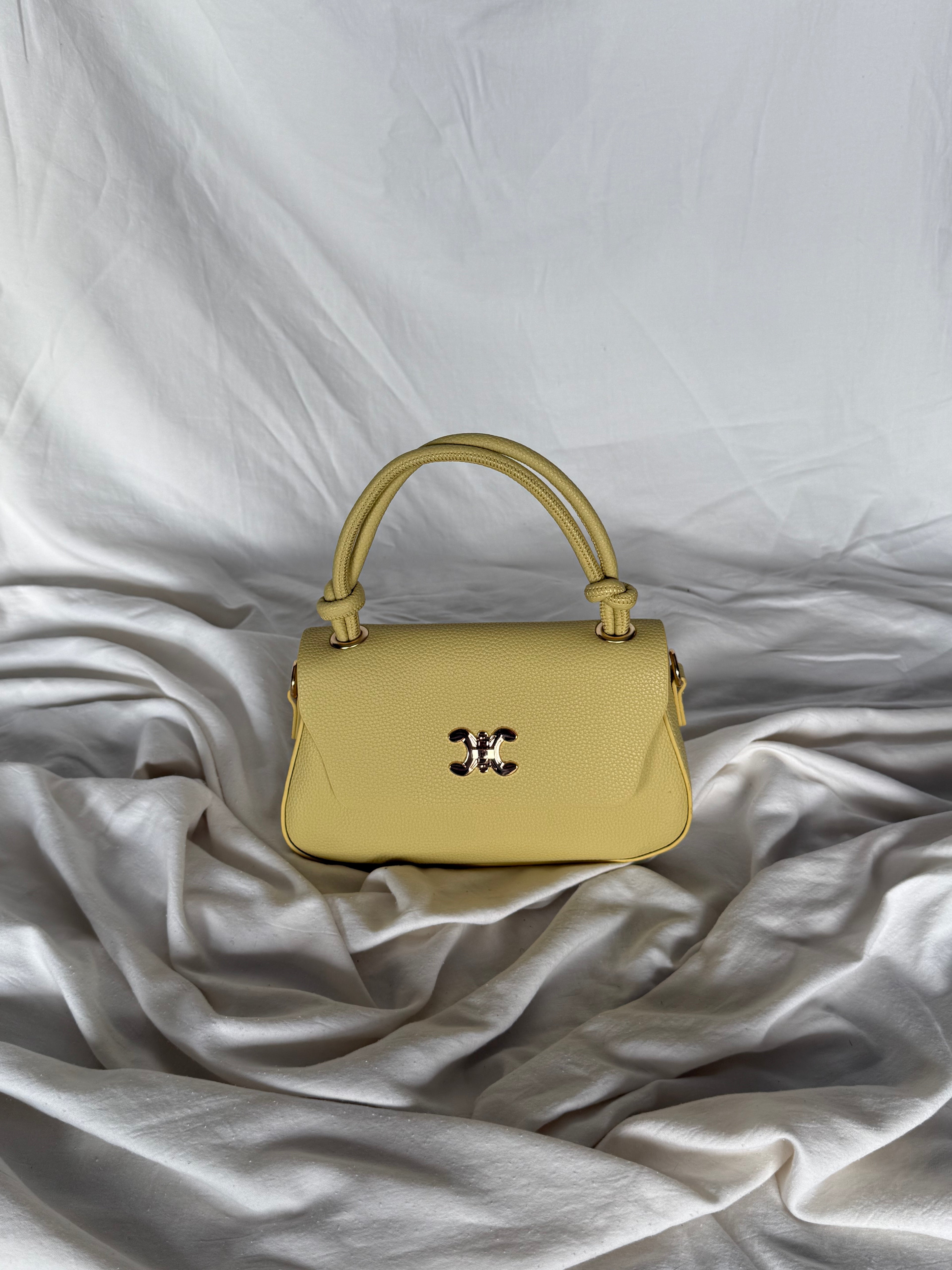 Κομψό κίτρινο παλ τσαντάκι χειρός με επιπλέον λουρί για να φοριέται και χιαστί