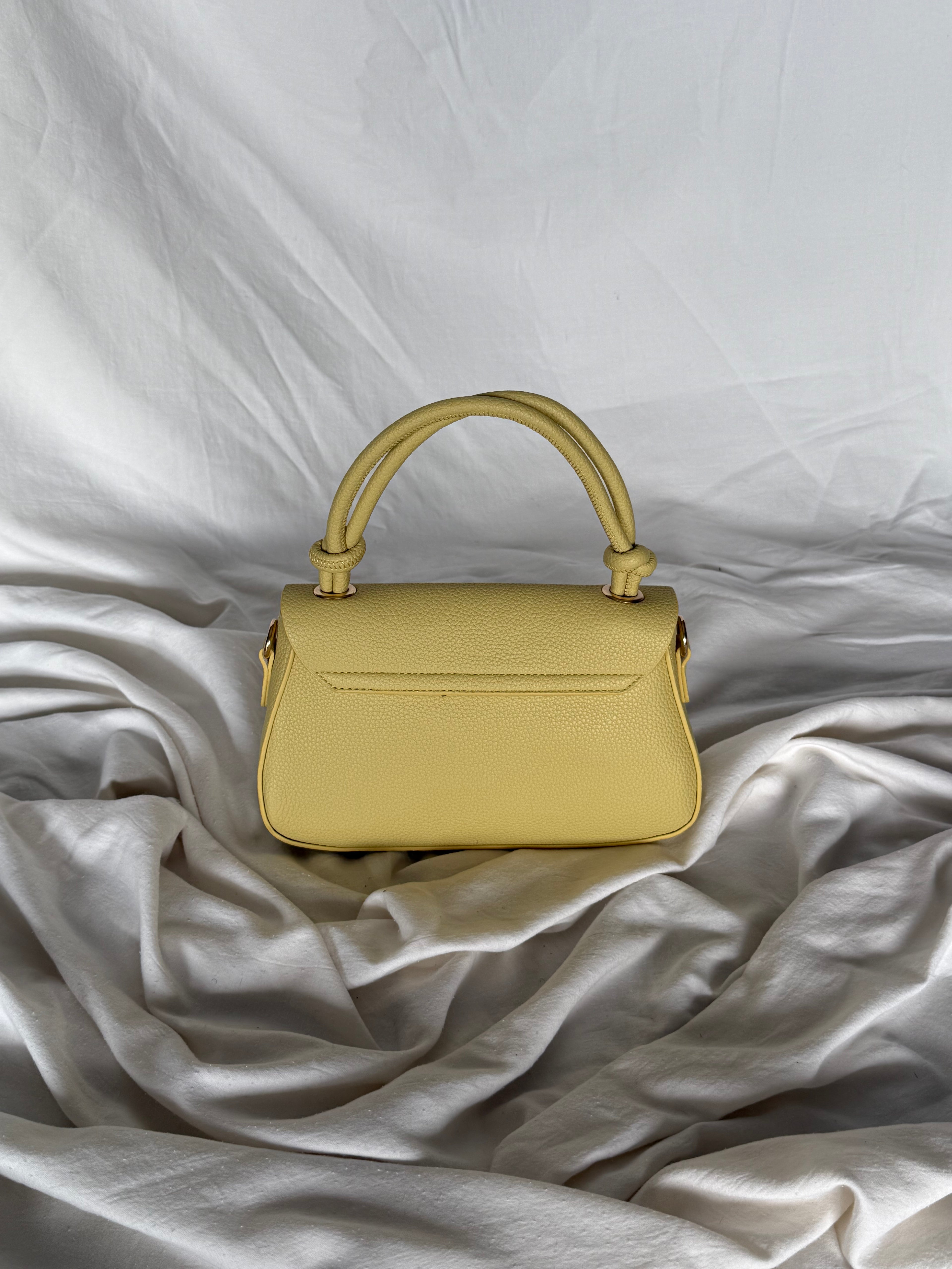 Κομψό κίτρινο παλ τσαντάκι χειρός με επιπλέον λουρί για να φοριέται και χιαστί