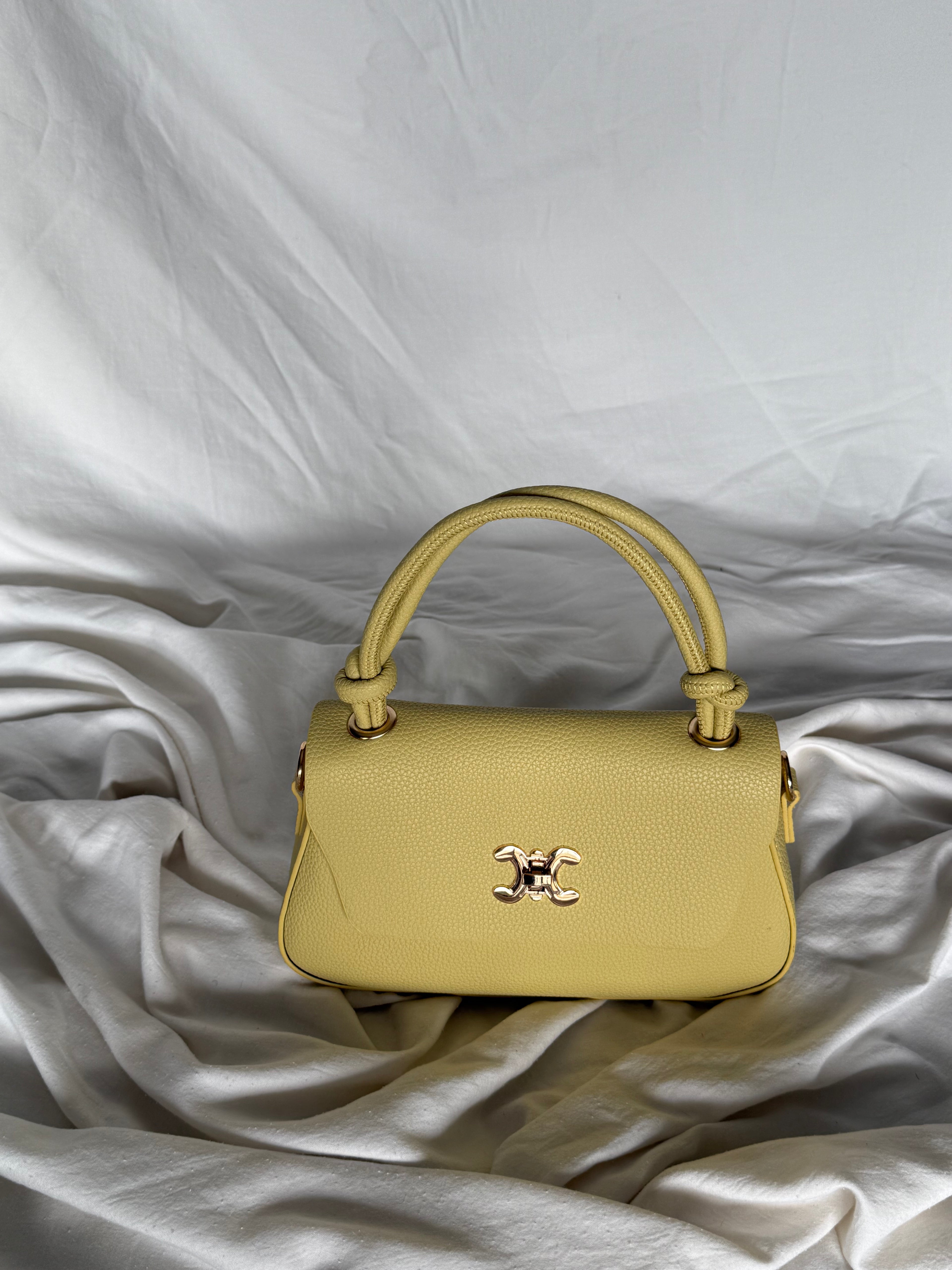 Κομψό κίτρινο παλ τσαντάκι χειρός με επιπλέον λουρί για να φοριέται και χιαστί