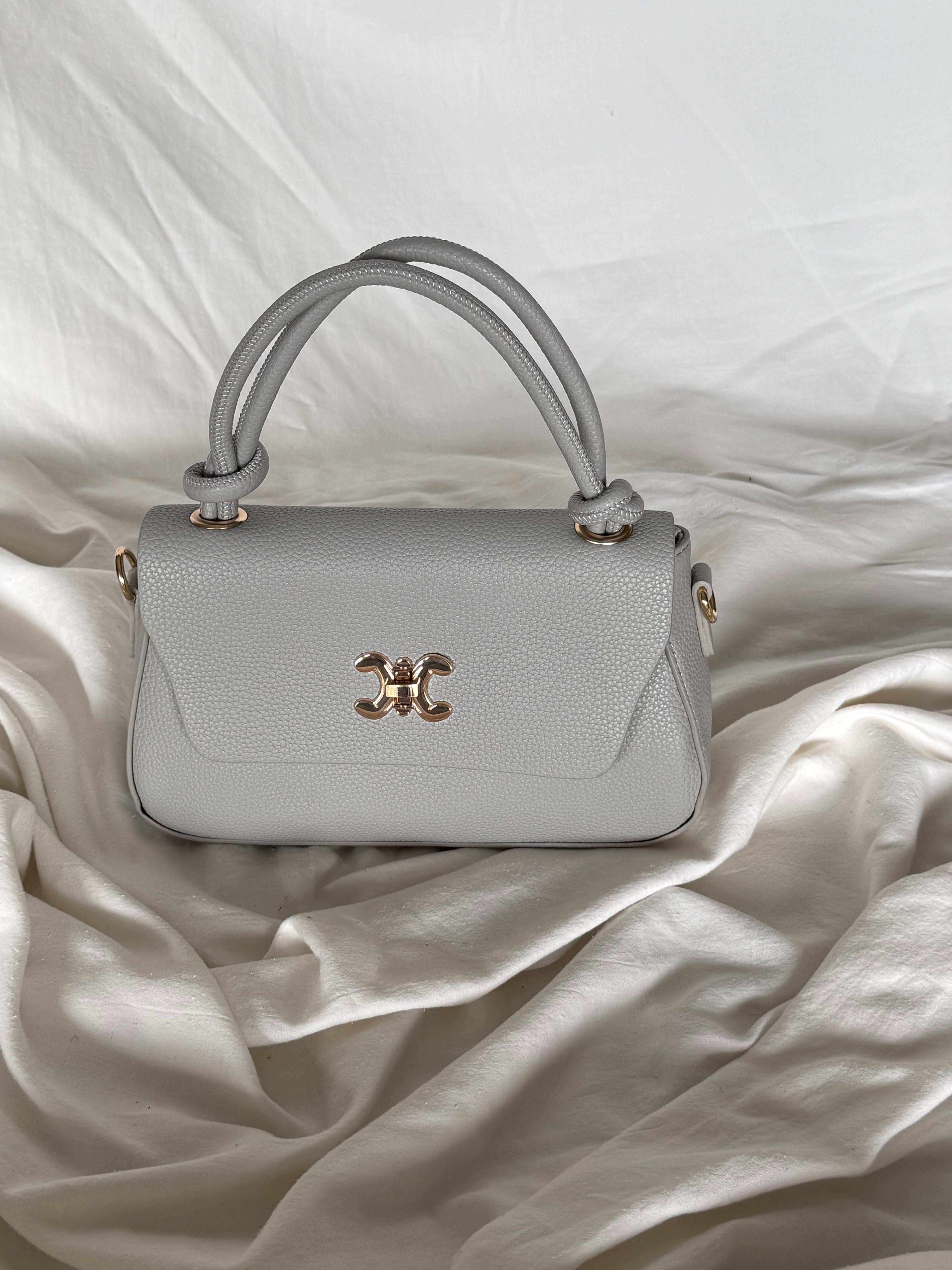 Κομψό γκρί τσαντάκι χειρός με επιπλέον λουρί για να φοριέται και χιαστί